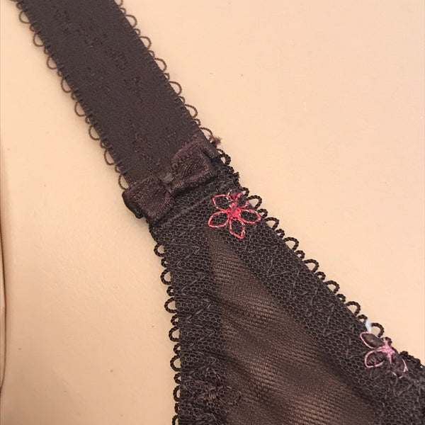 Tamarie bra strap detail with mocha mesh, pink floral embroidery, and bow accent on full-figure mannequin