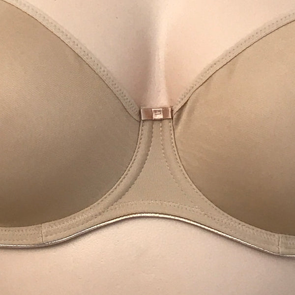 Detail view of Fantasie nude seamless bra showing the underbust and small satin bow at center gore.