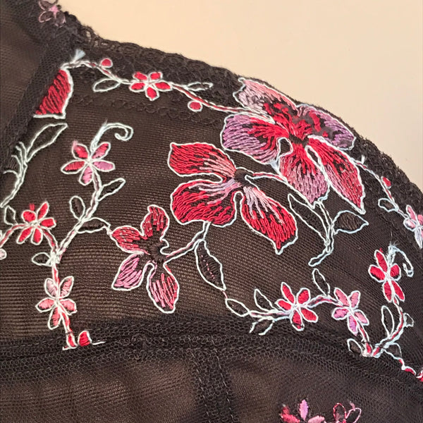 Detail of pink and red floral embroidery on sheer mesh of Tamarie bra