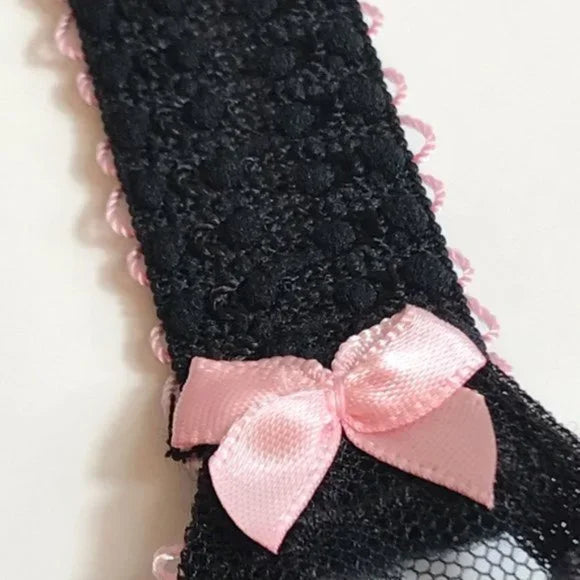 Arabella bra strap detail with elastic texture and satin pink bow, shown flat against mannequin