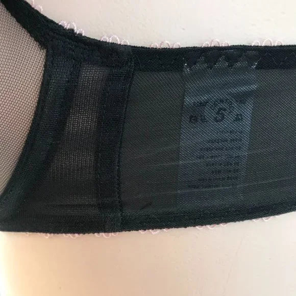 Arabella bra back band showing sheer black mesh and inner label, styled on mannequin