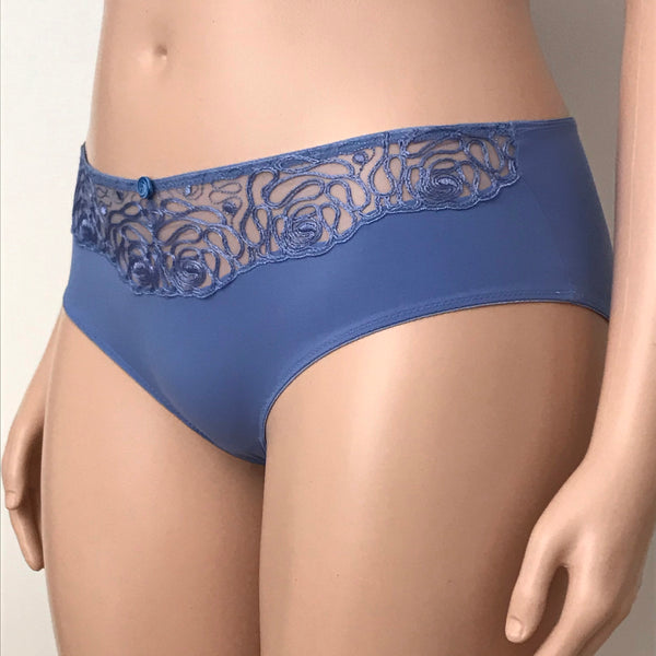 Left side view of Harmony brief in cornflower blue – sheer embroidered panel with floral swirl design across the waistband.